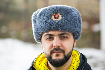 Caucasian man wearing ushanka winter hat with Soviet Union logo