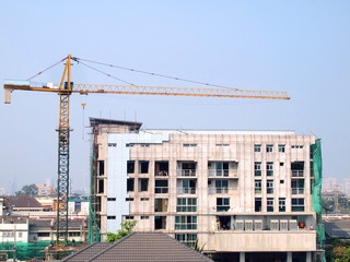 Industrial landscape with cranes on the blue sky