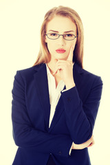 Wall Mural - Business woman in eyeglasses with finger on cheek.