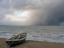 Lonely Boat On The Shore Of A Stormy Sea