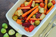 Roasted vegetables in oven with cutlery