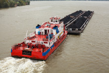 Tugboat Pushing A Heavy Barge