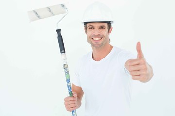 Aufkleber - Man holding paint roller while gesturing thumbs up