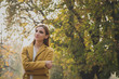 © tinx - Redhead girl posing in a city park
