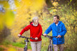 © Halfpoint - Active seniors walking with bike
