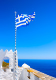 Fototapeta  - Greek flag at Hozoviotissa Monastery in Amorgos island in Greece
