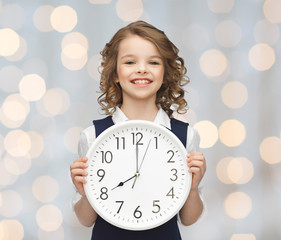 Wall Mural - smiling girl holding big clock