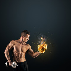 Wall Mural - Muscular man with dumbbells on dark background