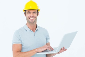 Poster - Carpenter using laptop  over white background
