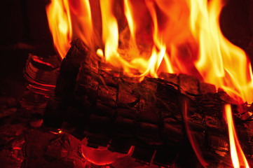 Fireplace burning. Warm burning and glowing fire in fireplace.