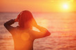 © Alex Photo - Young woman enjoying beautiful sunset over the sea