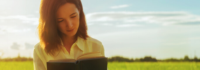 Sticker - Young woman reading a book in summer