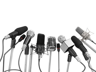 various microphones aligned at press conference isolated over a