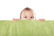 cute baby boy peek behind the green towel