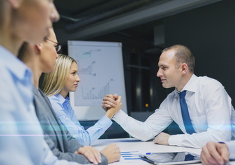 Wall Mural - businesswoman and businessman arm wrestling