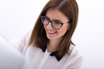 Poster - Closeup portrait of a young happy businesswoman in glasses