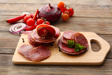Wall Mural - Sliced salami with chili pepper, cherry tomatoes, onion and