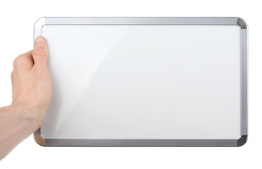 Wall Mural - Hand holding an empty whiteboard (magnetic board) isolated