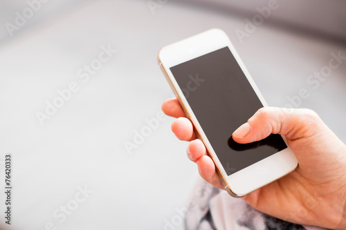 Fotografía Mujer que sostiene el teléfono inteligente
