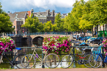 Bicycles On A Bridge Over The Canals Of Amsterdam
