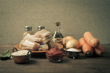 Wall Mural - Pieces of fresh fish on a plate, vegetables, flour, tomatoe past