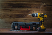 Electric Screwdriver On A Wooden Background