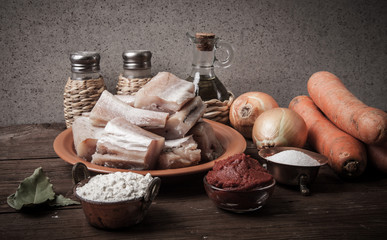 Wall Mural - Pieces of fresh fish on a plate, vegetables, flour, tomatoe past