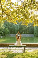 Wall Mural - Caucasian woman practicing yoga at lake