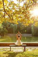 Wall Mural - Caucasian woman practicing yoga at lake