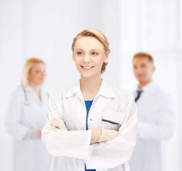 Canvas Print - smiling young female doctor in hospital