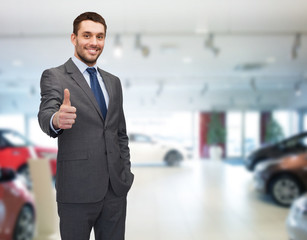 Wall Mural - smiling businessman showing thumbs up