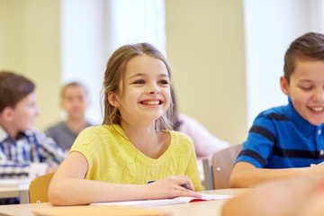 Sticker - group of school kids writing test in classroom