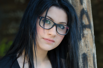 Round face lady with glasses and black clothes