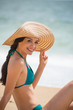 © jackfrog - Portrait of a beautiful girl with a big hat at the beach