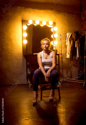 Fotografie, Obraz blonde woman posing on chair at dressing room in theater