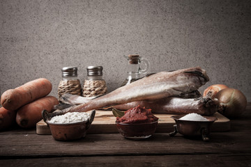 Wall Mural - Still life with fish, vegetables and spices on a wooden board. T