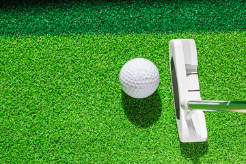 Wall Mural - Golf club and golf ball on green grass background.