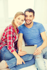 Poster - smiling happy couple with tablet pc at home