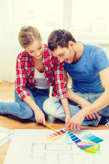 Sticker - smiling couple looking at color samples at home