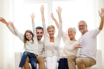 Canvas Print - happy family sitting on sofa at home