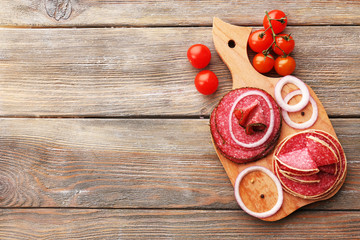 Wall Mural - Sliced salami with cherry tomatoes, onion and spices