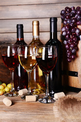 Poster - Different wine on table on wooden background