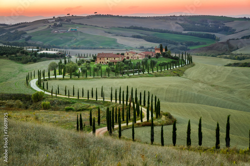 Sunset and winding road wit...