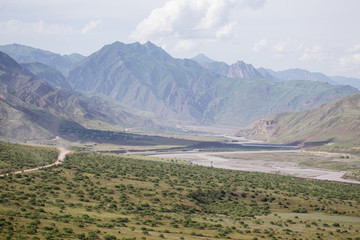 Village in valley in the foothills of the Fann mountains. Landsc