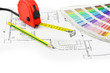© JANNTA - Tape measure, pencil and color sample over a construction plan d