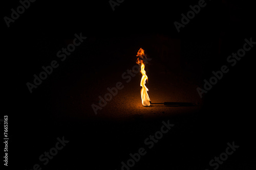 Fotografía Burning Torch in the Night at black background