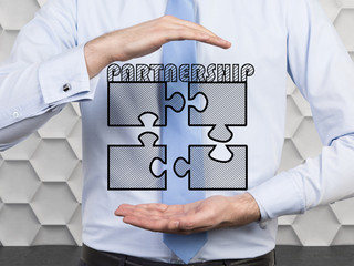 Canvas Print - businessman holding four puzzle