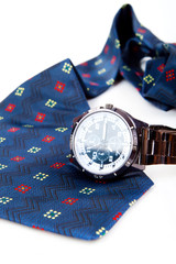 classic business watches and abstract blue necktie isolated on w