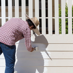 Wall Mural - worker painted white fence with brush