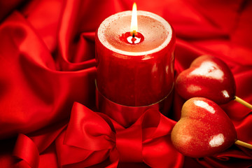 Canvas Print - Valentine's Day. Valentine red hearts and candle on red silk